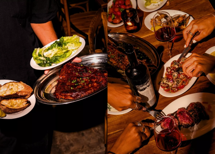 A server carrying grilled ribs, charred sourdough and a green salad at Papi Sapi Uluwatu, with a shared steak-and-wine spread on a wooden table.