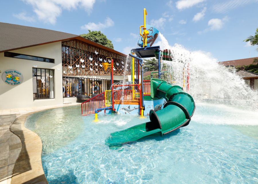 Green spiral water slide and splash pad at the Kids Water Fun Zone, Bali Dynasty Resort, Kuta