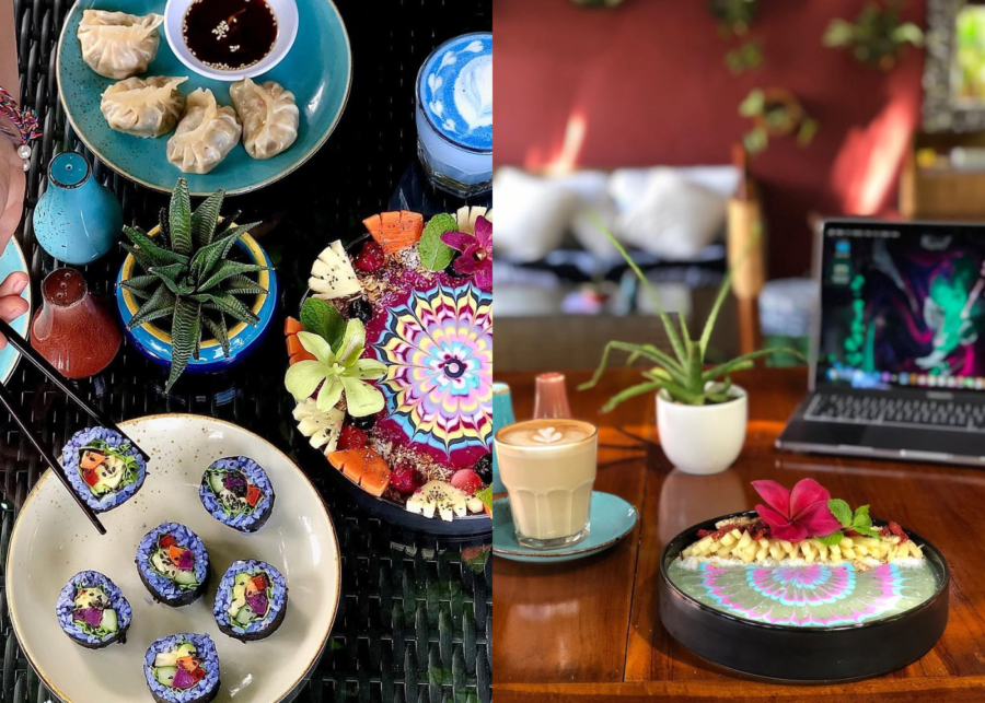 A colourful spread at Blend Cafe in Sanur, with steamed dumplings, blue rice sushi rolls and a vivid rainbow smoothie bowl, beside a latte and a laptop on a wooden table.