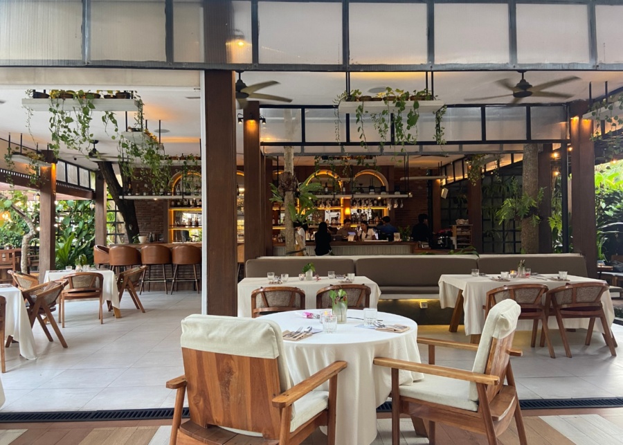 Semi-outdoor dining tables at Cork French Tavern restaurant and wine bar in Sanur, Bali, Indonesia