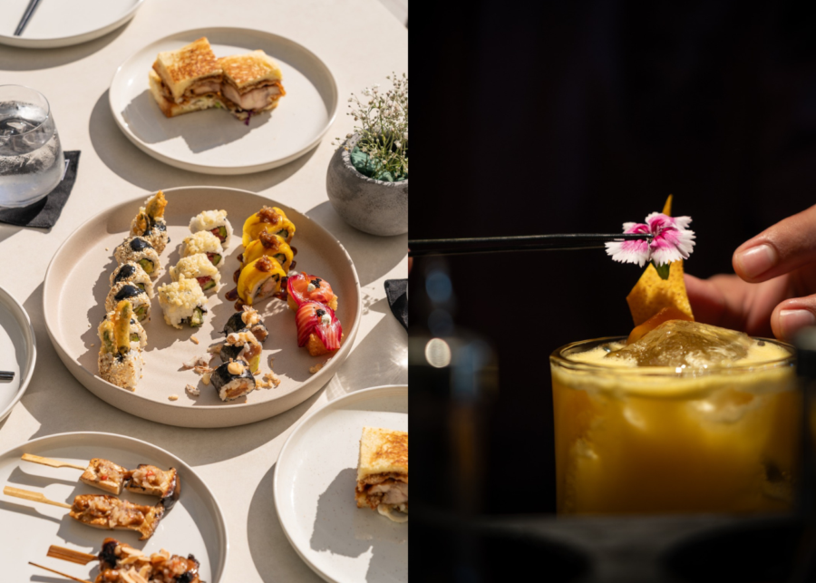 A spread of Chicken Sando, sushi rolls and skewers on the table at MYKAZA, beside a cocktail garnished with an edible flower.