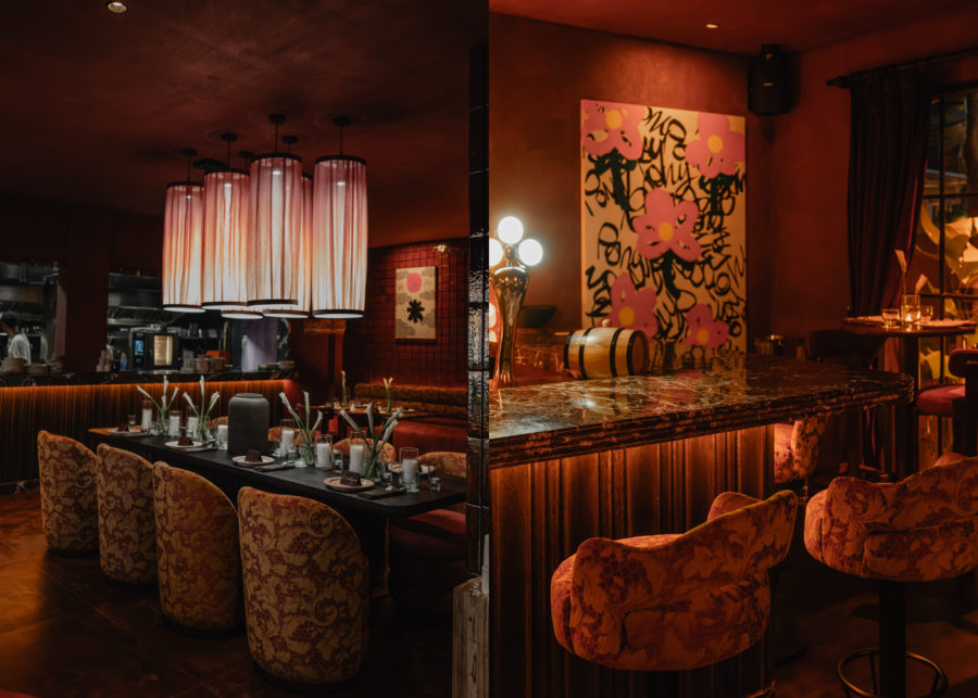 Inside Pony in Berawa, with a long dining table under pleated pendant lamps, floral upholstered chairs and a bar corner with a large pink flower painting.