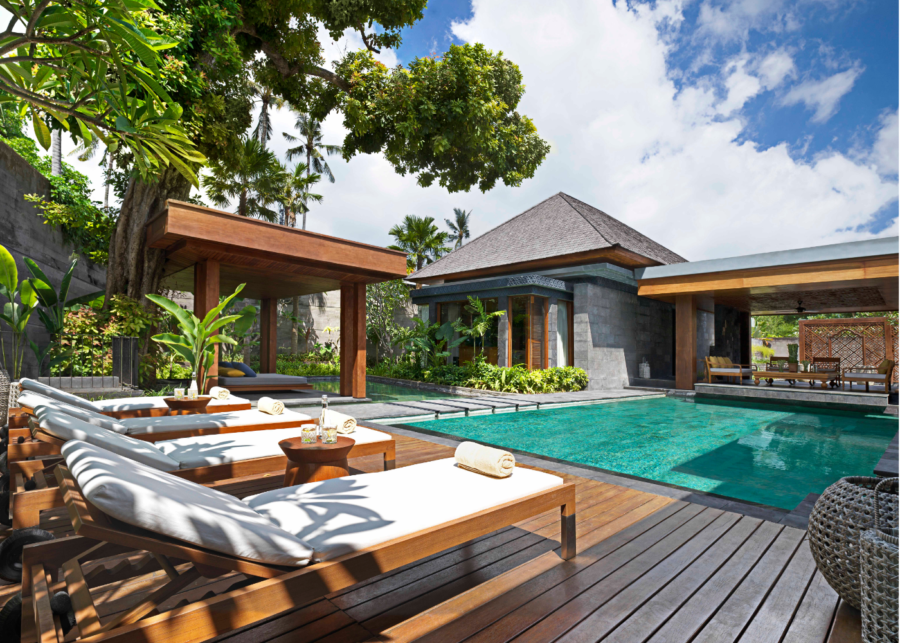 Two-bedroom pool villa with sun loungers on a timber deck beside a private pool and an open-air living pavilion