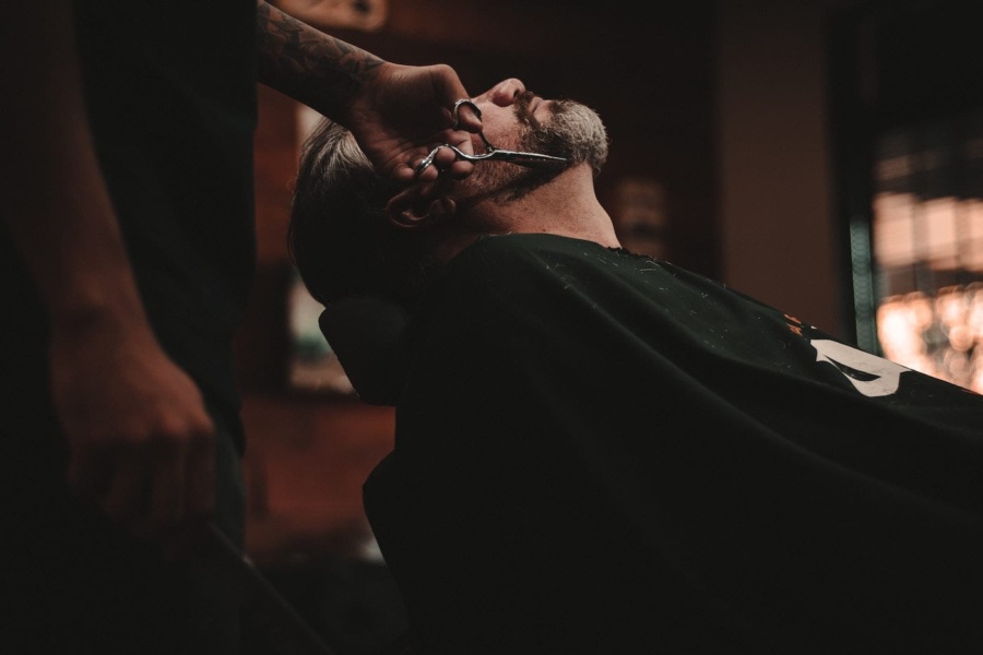 a person trimming beard