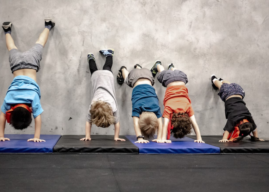 five kids doing wall stand