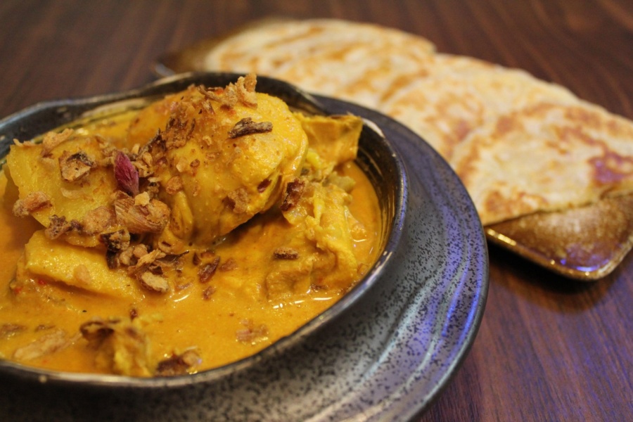 a bowl of curry with naan