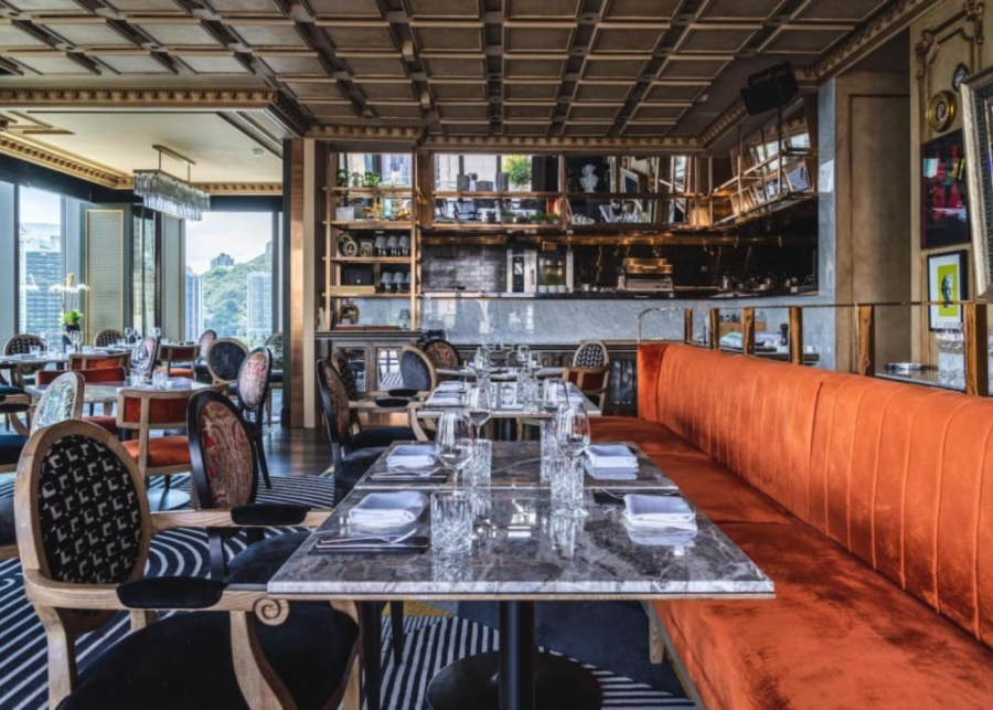 a bright environment with red velvet sofas