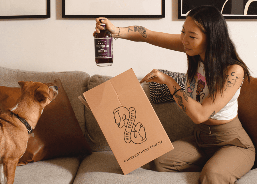 girl and dog unboxing four pillars shiraz gin