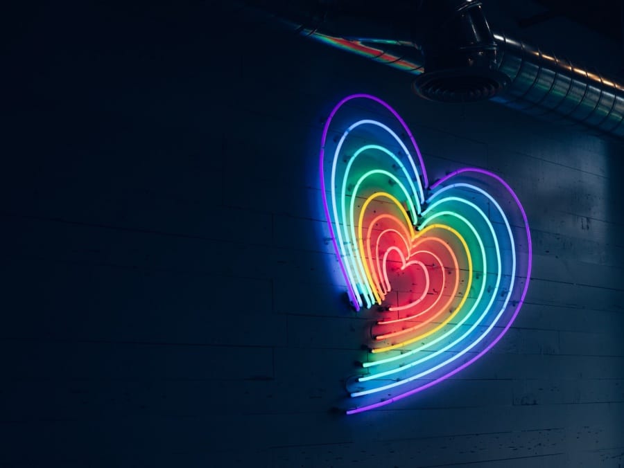 a neon rainbow heart light