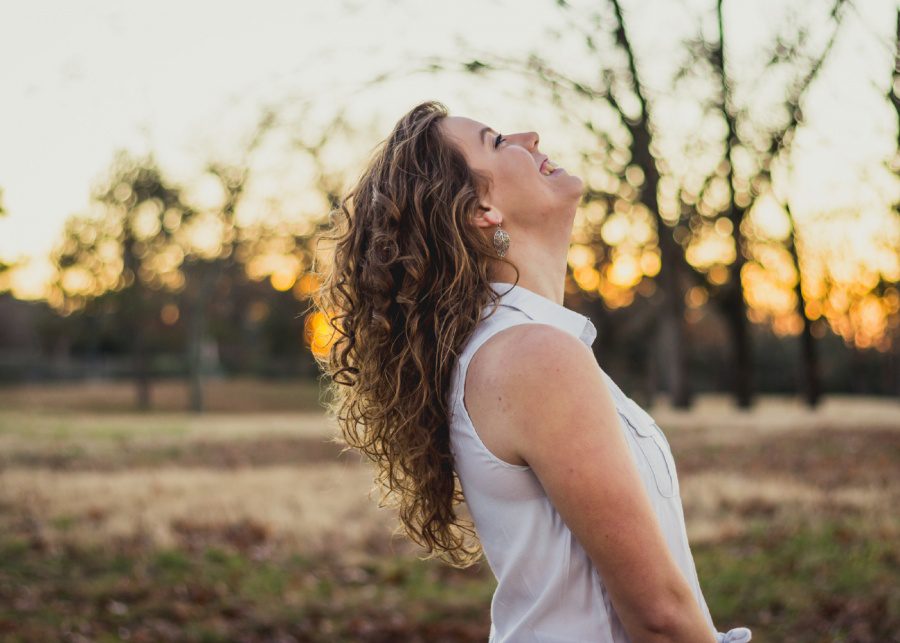 woman smiling towards the sky success