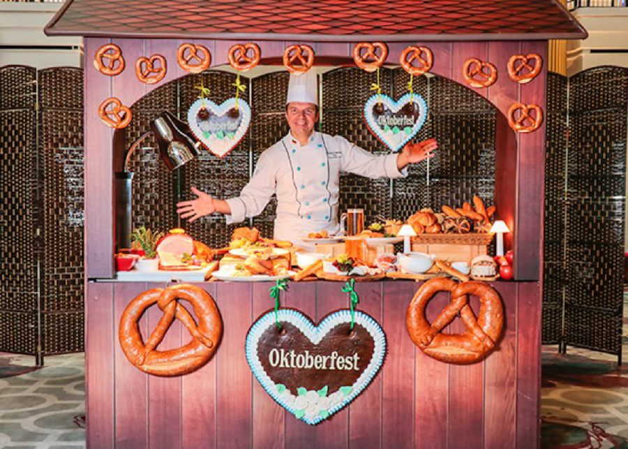 a man inside a booth with pretzels for Oktoberfest