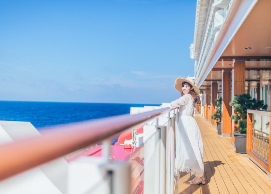 a lady standing on the corridor on the upper deck