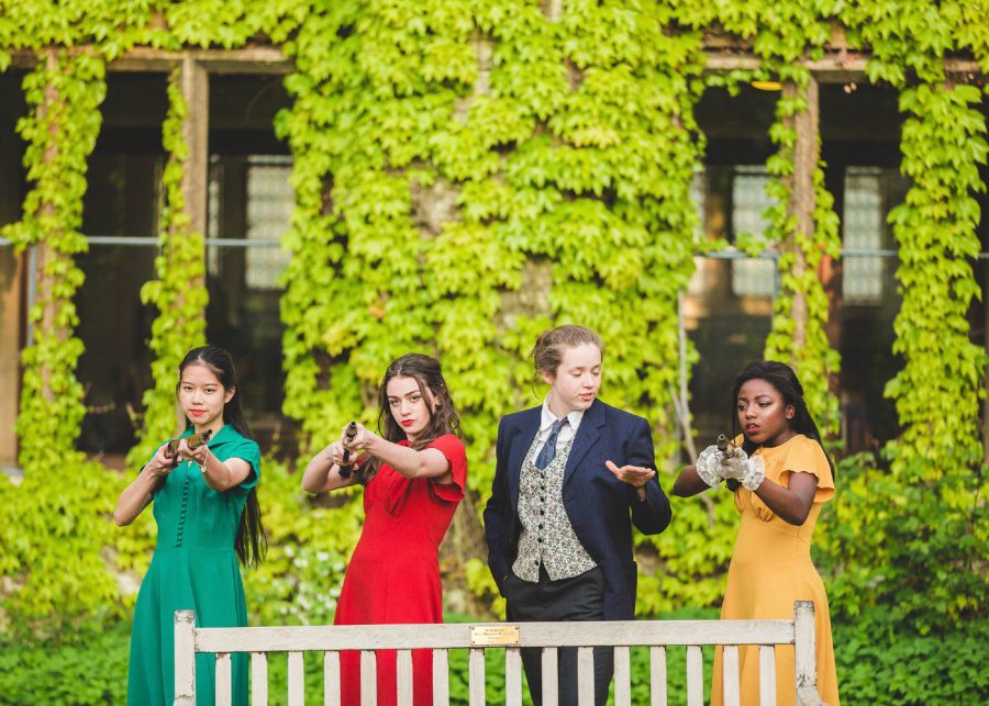 boarding school uk cheltenham ladies college four girls students holding fake guns rifles drama play theatre