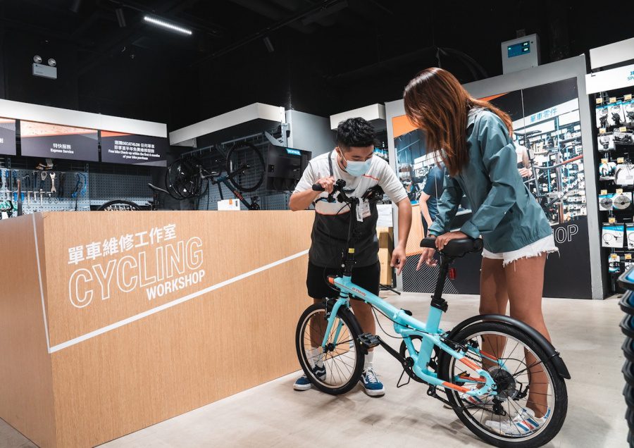 a staff explaining how the bike works to a customer