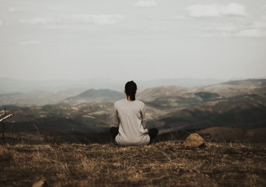 a lady sitting by herself on a mountain / 25 things I have learned at 25