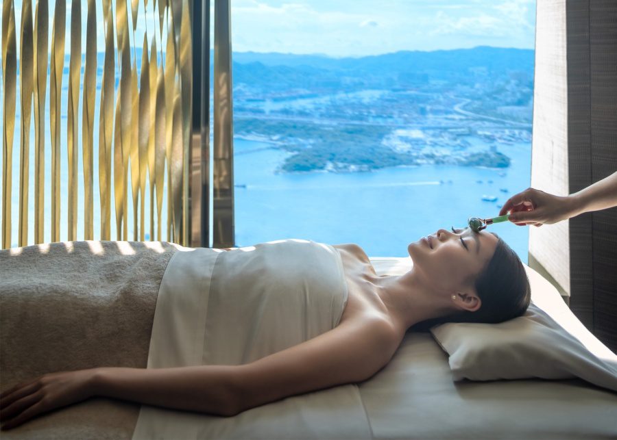 woman getting face rolled by a jade roller