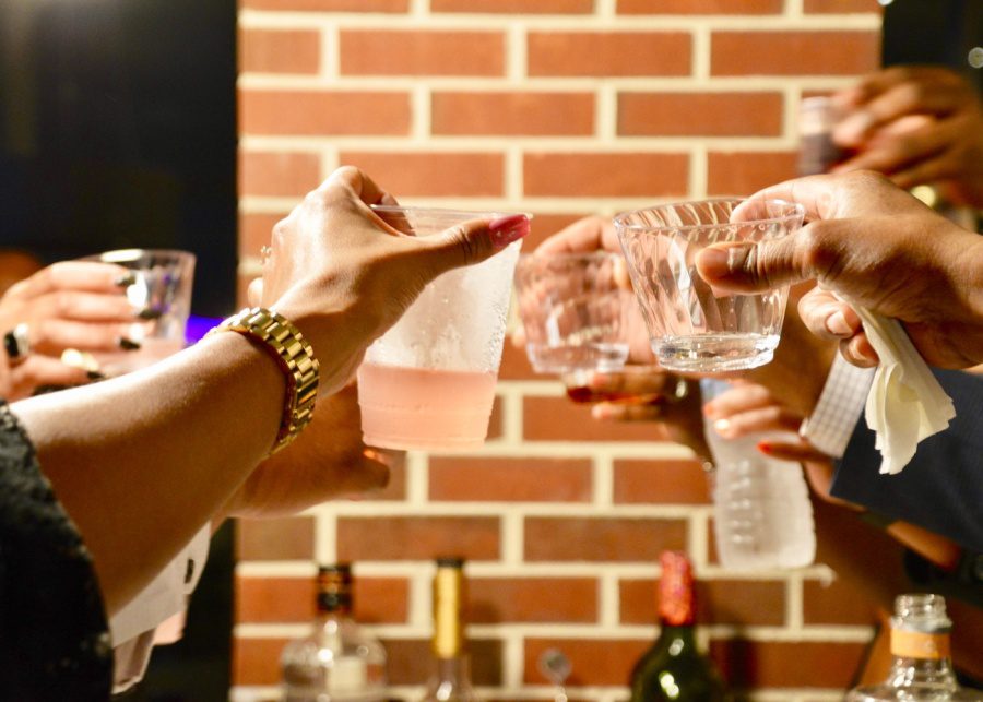 hands with drinks clinking cups