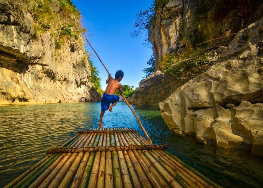 wiki loves earth boy guiding a raft on the river