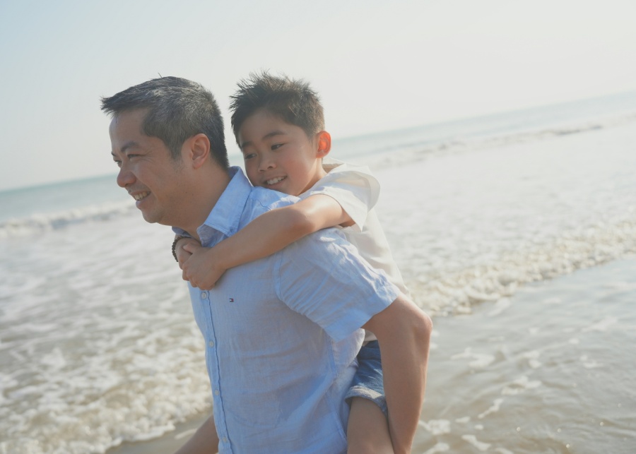 Withers fathers custody rights - A man piggybacking his son on the beach